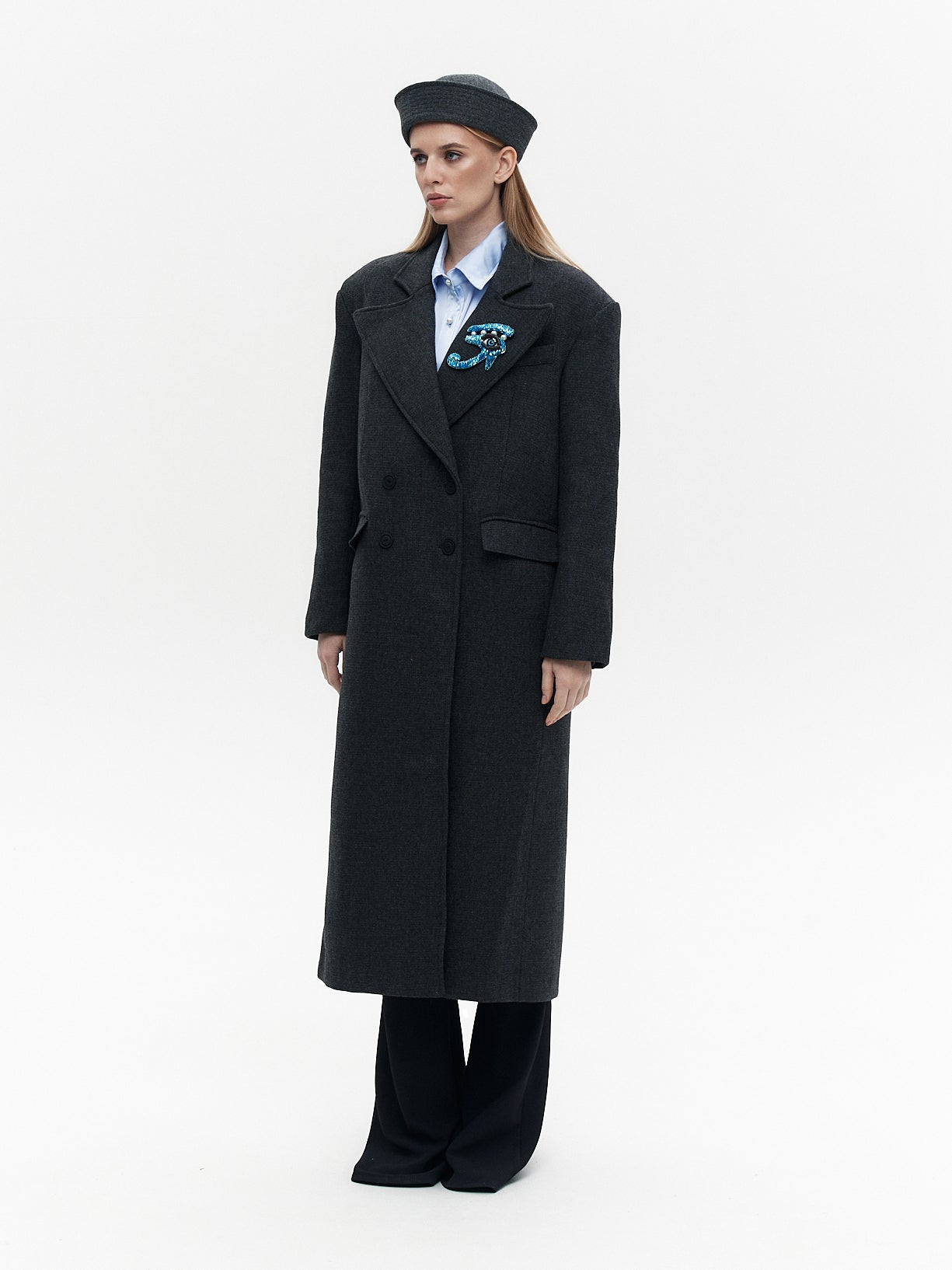 Wool coat with the blue eye patch