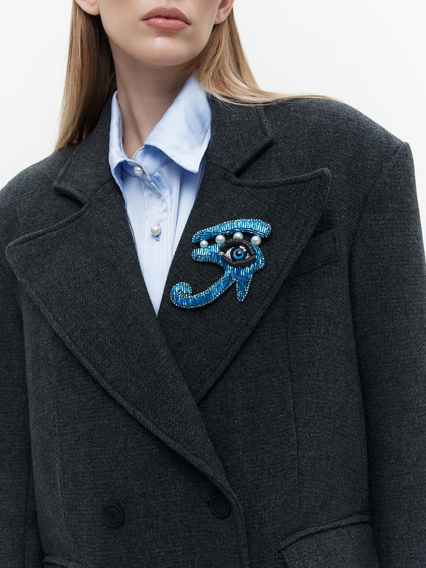 Wool coat with the blue eye patch